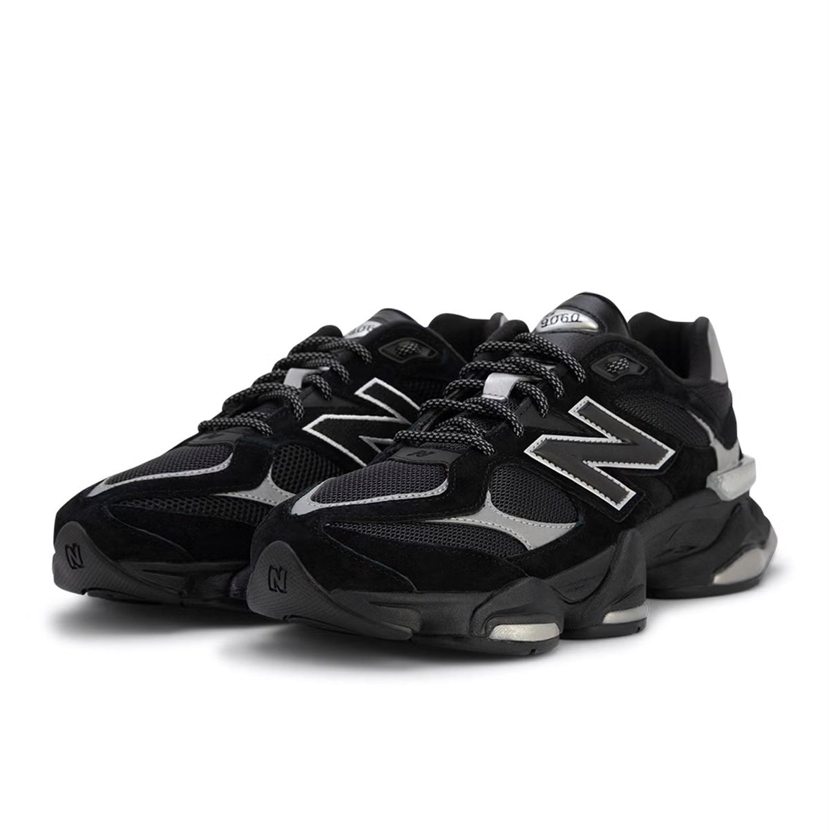 Black New Balance sneakers on a white background